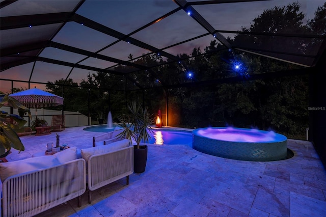 30801 Parrot Reef Ct, Wesley Chapel, FL 33545 - pool at twilight featuring a pool with connected hot tub, a patio, and outdoor lounge area