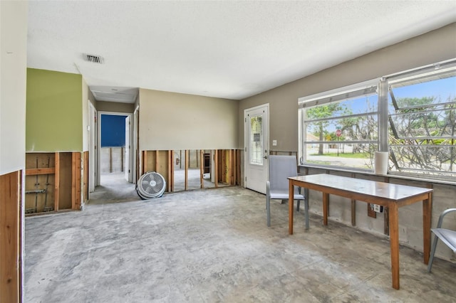 123 14th Ave, Indian Rocks Beach, FL 33785 - unfurnished living room with concrete floors and a textured ceiling