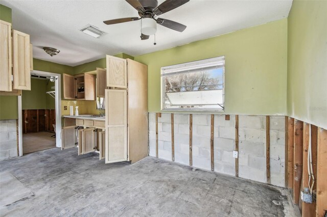 123 14th Ave, Indian Rocks Beach, FL 33785 - kitchen featuring light brown cabinets, light countertops, ceiling fan, and unfinished concrete floors
