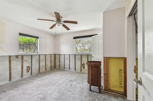 123 14th Ave, Indian Rocks Beach, FL 33785 - empty room featuring healthy amount of natural light, a ceiling fan, and a textured ceiling