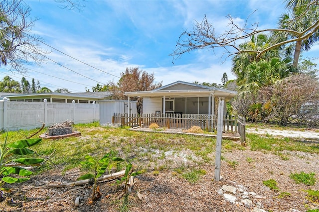 123 14th Ave, Indian Rocks Beach, FL 33785 - rear view of property featuring a sunroom