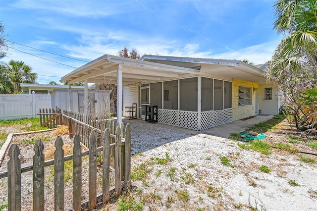 123 14th Ave, Indian Rocks Beach, FL 33785 - view of home's exterior featuring a sunroom, driveway, and an attached carport