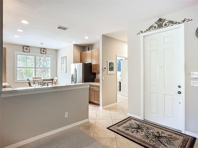 15860 Aurora Lake Cir, Wimauma, FL 33598 - kitchen featuring stainless steel refrigerator with ice dispenser, light tile patterned floors, baseboards, and recessed lighting