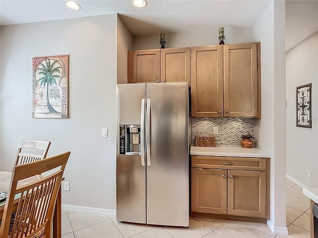 15860 Aurora Lake Cir, Wimauma, FL 33598 - kitchen with stainless steel refrigerator with ice dispenser, backsplash, light countertops, light tile patterned floors, and recessed lighting
