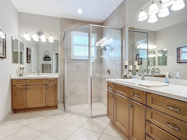 15860 Aurora Lake Cir, Wimauma, FL 33598 - bathroom featuring a chandelier, a shower stall, tile patterned floors, and two vanities