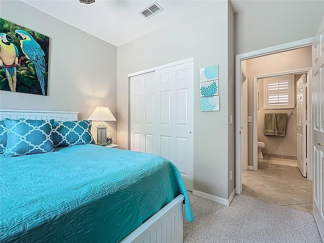 15860 Aurora Lake Cir, Wimauma, FL 33598 - bedroom with a closet, light tile patterned floors, baseboards, and light carpet