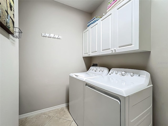 15860 Aurora Lake Cir, Wimauma, FL 33598 - washroom with cabinet space, washer and dryer, baseboards, and light tile patterned flooring