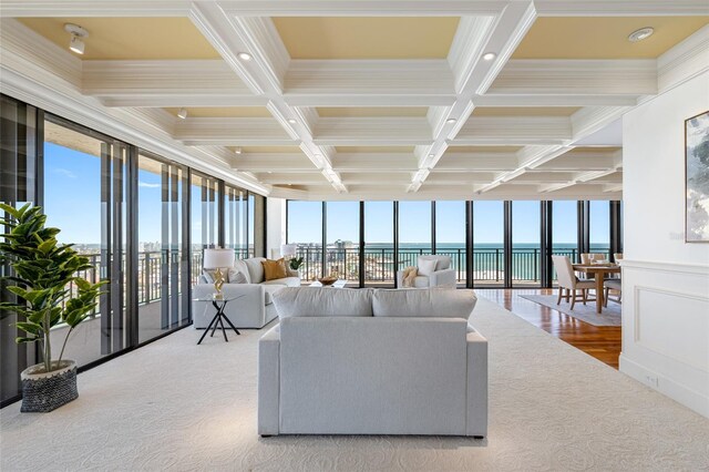 7600 Bayshore Dr Unit 1201A, Treasure Island, FL 33706 - living area featuring coffered ceiling, beamed ceiling, a water view, plenty of natural light, and ornamental molding