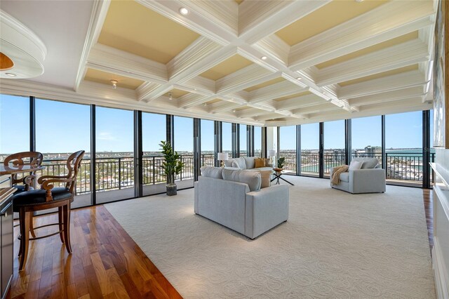 7600 Bayshore Dr Unit 1201A, Treasure Island, FL 33706 - carpeted living area with a wall of windows, beamed ceiling, coffered ceiling, crown molding, and wood finished floors