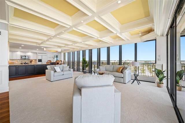 7600 Bayshore Dr Unit 1201A, Treasure Island, FL 33706 - living area featuring coffered ceiling, beamed ceiling, carpet flooring, crown molding, and floor to ceiling windows