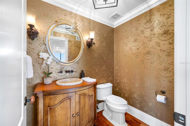 7600 Bayshore Dr Unit 1201A, Treasure Island, FL 33706 - half bath with wood finished floors, toilet, vanity, and ornamental molding