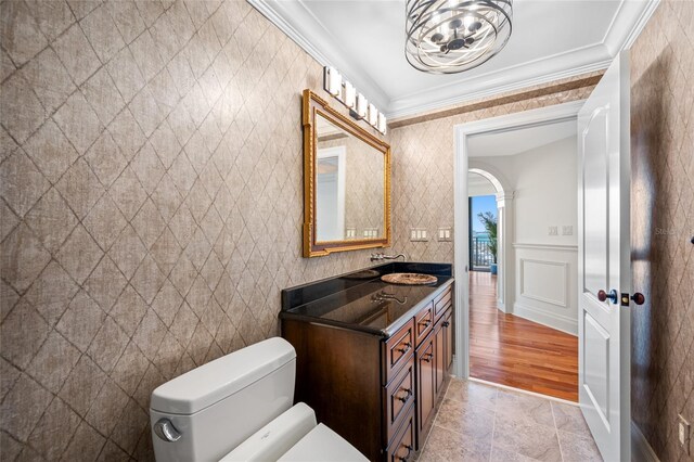 7600 Bayshore Dr Unit 1201A, Treasure Island, FL 33706 - bathroom featuring toilet, vanity, ornamental molding, and a chandelier