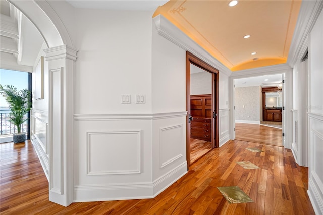 7600 Bayshore Dr Unit 1201A, Treasure Island, FL 33706 - corridor with a decorative wall, wood-type flooring, a wainscoted wall, recessed lighting, and decorative columns
