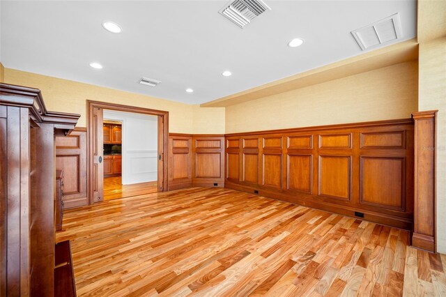 7600 Bayshore Dr Unit 1201A, Treasure Island, FL 33706 - empty room with light wood-style floors, a decorative wall, wainscoting, and recessed lighting