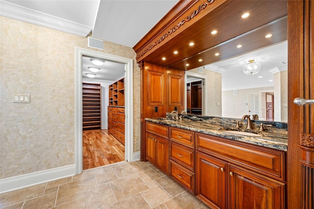 7600 Bayshore Dr Unit 1201A, Treasure Island, FL 33706 - bathroom with crown molding, double vanity, baseboards, stone finish floors, and recessed lighting