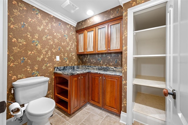 7600 Bayshore Dr Unit 1201A, Treasure Island, FL 33706 - bathroom with vanity, toilet, wallpapered walls, and tile patterned flooring