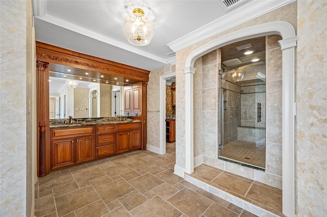 7600 Bayshore Dr Unit 1201A, Treasure Island, FL 33706 - full bath with double vanity, a shower stall, decorative columns, a chandelier, and stone tile flooring