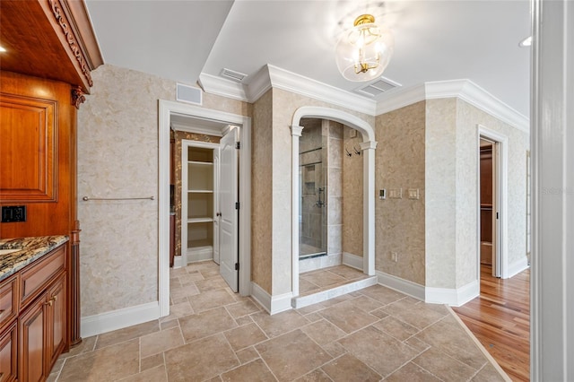 7600 Bayshore Dr Unit 1201A, Treasure Island, FL 33706 - bathroom with a stall shower, vanity, a walk in closet, crown molding, and a chandelier
