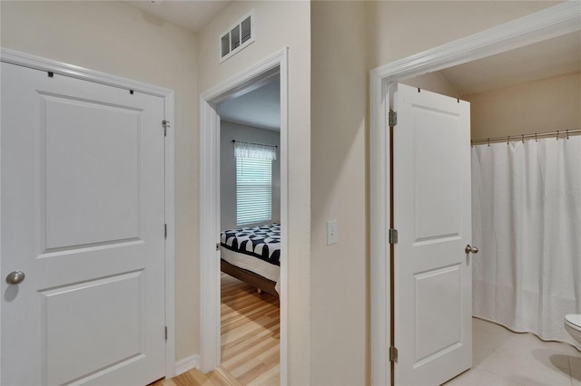 1398 Crescent Hoop Way, Wesley Chapel, FL 33543 - hallway with baseboards and light wood-type flooring