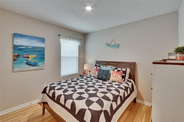 1398 Crescent Hoop Way, Wesley Chapel, FL 33543 - bedroom with light wood-type flooring and baseboards