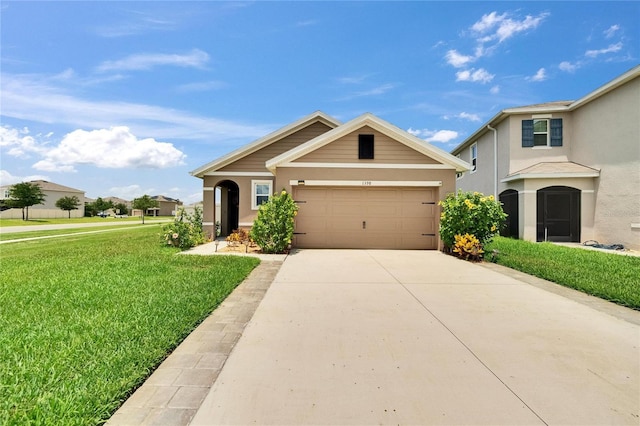 1398 Crescent Hoop Way, Wesley Chapel, FL 33543 - view of front of property featuring a front lawn, a garage, driveway, and stucco siding