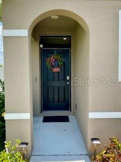 1398 Crescent Hoop Way, Wesley Chapel, FL 33543 - property entrance with stucco siding