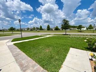 1398 Crescent Hoop Way, Wesley Chapel, FL 33543 - view of community featuring a lawn