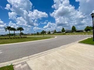 1398 Crescent Hoop Way, Wesley Chapel, FL 33543 - view of asphalt road with street lights