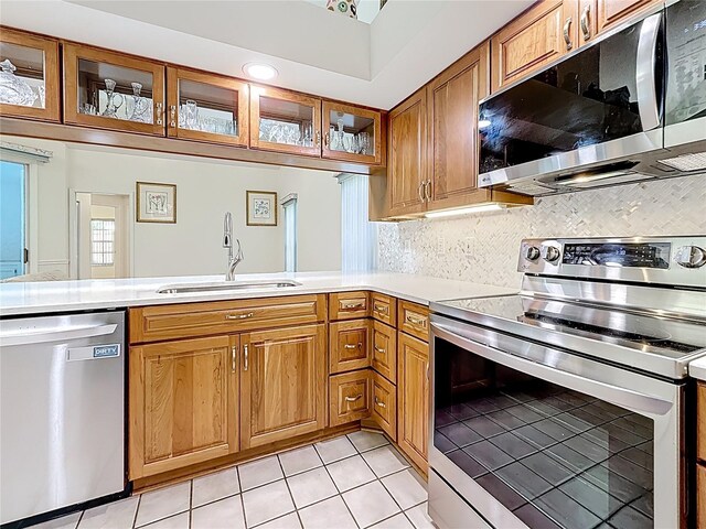 2973 Spring Oak Ct, Palm Harbor, FL 34684 - kitchen featuring appliances with stainless steel finishes, a sink, light countertops, and light tile patterned floors