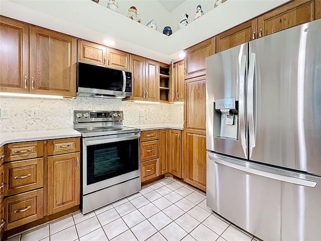 2973 Spring Oak Ct, Palm Harbor, FL 34684 - kitchen featuring stainless steel appliances, light countertops, light tile patterned floors, and brown cabinets