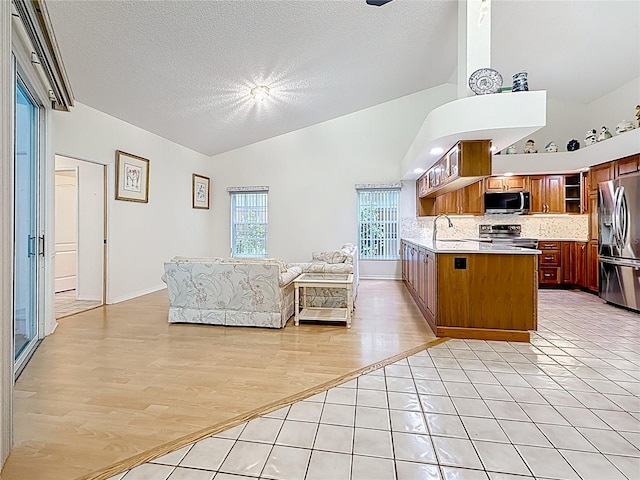 2973 Spring Oak Ct, Palm Harbor, FL 34684 - kitchen with appliances with stainless steel finishes, open floor plan, backsplash, open shelves, and a sink