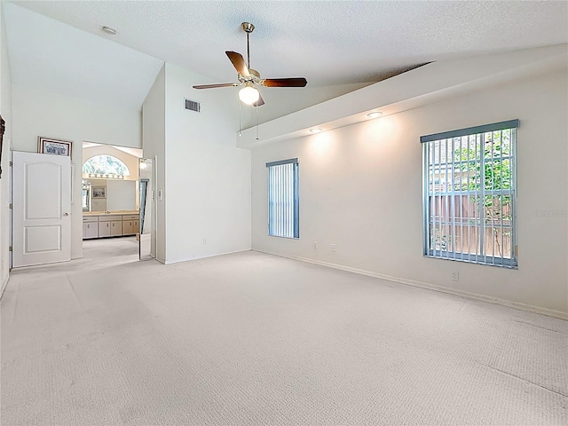 2973 Spring Oak Ct, Palm Harbor, FL 34684 - empty room with light carpet, a ceiling fan, high vaulted ceiling, baseboards, and a textured ceiling