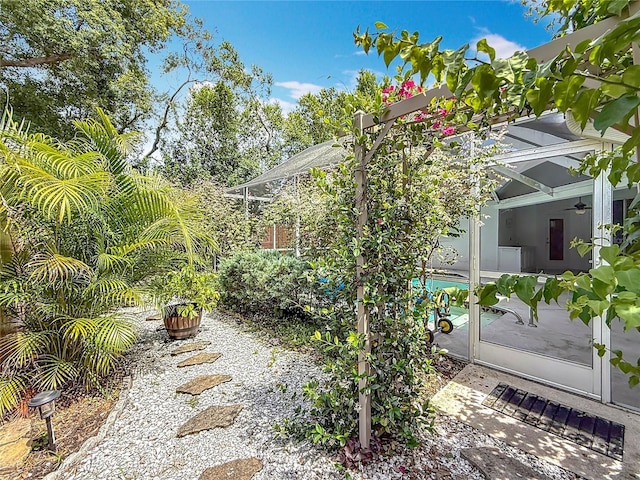 2973 Spring Oak Ct, Palm Harbor, FL 34684 - view of side of home with ceiling fan and a patio