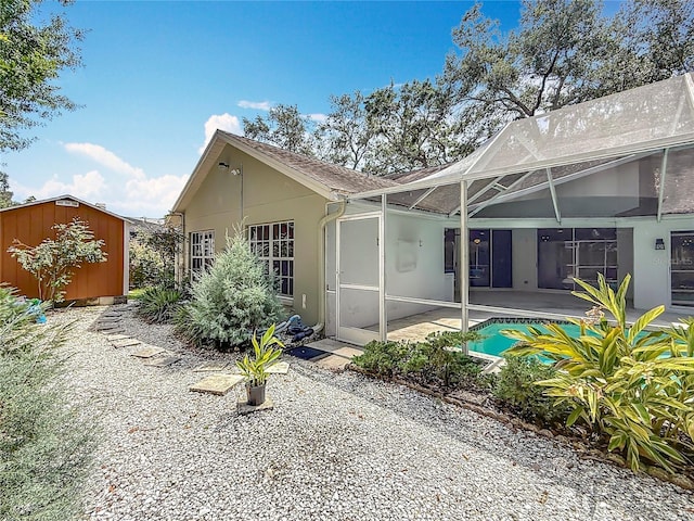 2973 Spring Oak Ct, Palm Harbor, FL 34684 - rear view of property with stucco siding, a patio area, an outdoor pool, and a lanai