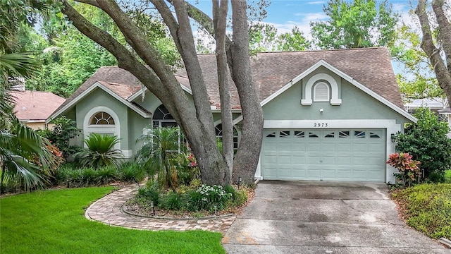 2973 Spring Oak Ct, Palm Harbor, FL 34684 - view of front facade featuring a shingled roof, stucco siding, driveway, and a garage