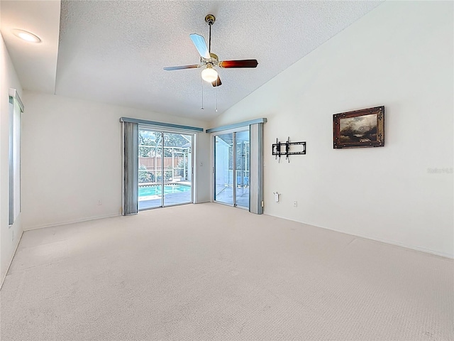 2973 Spring Oak Ct, Palm Harbor, FL 34684 - carpeted spare room featuring a textured ceiling, lofted ceiling, and a ceiling fan