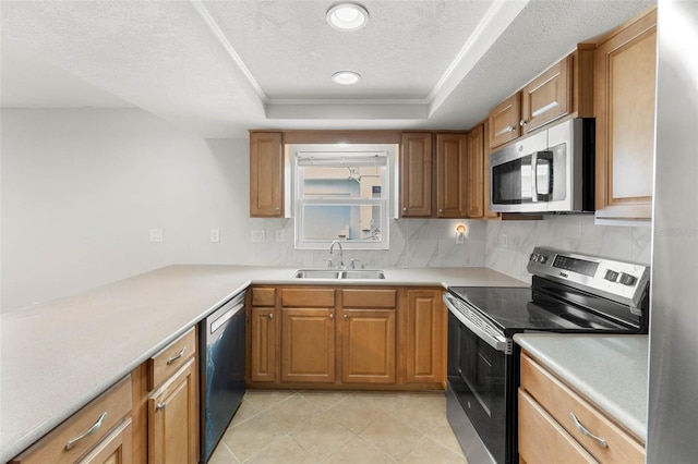 4299 Bellaire Dr, Hernando Beach, FL 34607 - kitchen featuring appliances with stainless steel finishes, a sink, decorative backsplash, a raised ceiling, and a textured ceiling