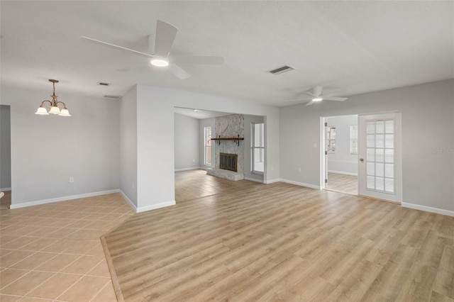 4299 Bellaire Dr, Hernando Beach, FL 34607 - unfurnished living room featuring a ceiling fan, a chandelier, a fireplace, and baseboards