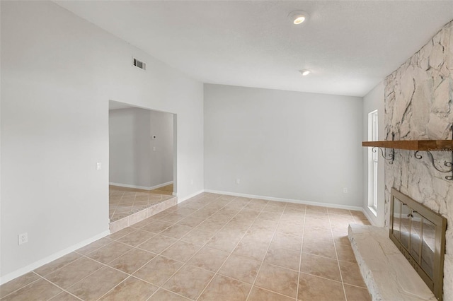 4299 Bellaire Dr, Hernando Beach, FL 34607 - unfurnished living room featuring light tile patterned floors, a stone fireplace, and baseboards