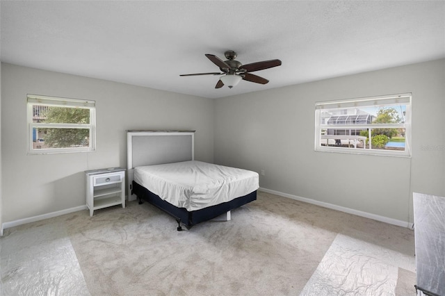 4299 Bellaire Dr, Hernando Beach, FL 34607 - bedroom featuring carpet, baseboards, and ceiling fan