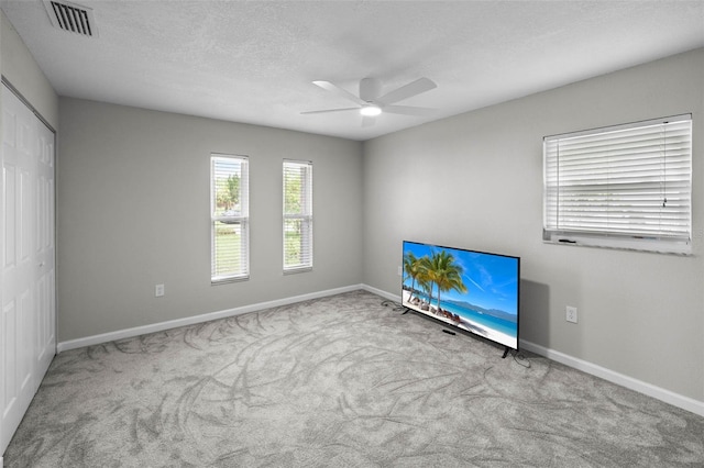 4299 Bellaire Dr, Hernando Beach, FL 34607 - unfurnished bedroom with baseboards, carpet floors, a closet, ceiling fan, and a textured ceiling