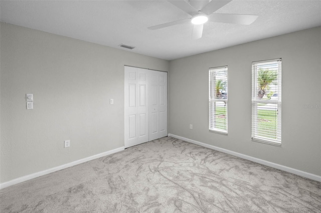 4299 Bellaire Dr, Hernando Beach, FL 34607 - unfurnished bedroom featuring carpet flooring, baseboards, a closet, and ceiling fan