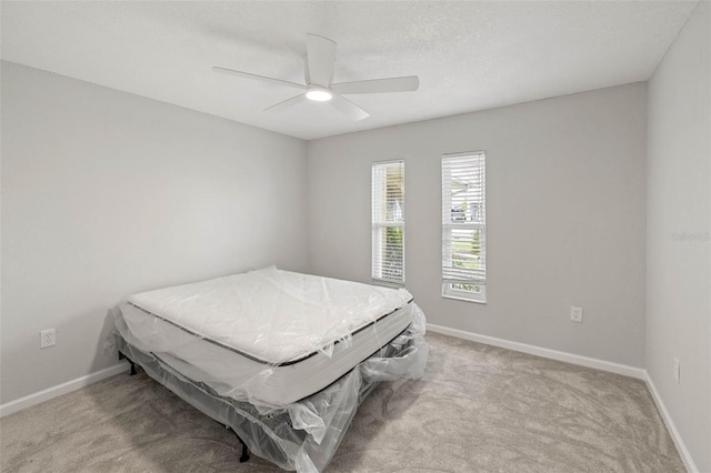 4299 Bellaire Dr, Hernando Beach, FL 34607 - bedroom featuring carpet flooring, baseboards, and a ceiling fan