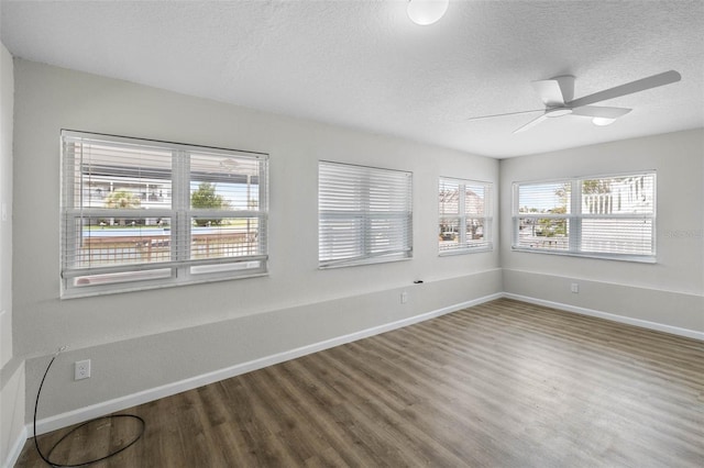 4299 Bellaire Dr, Hernando Beach, FL 34607 - unfurnished room with baseboards, wood finished floors, a textured ceiling, and a ceiling fan