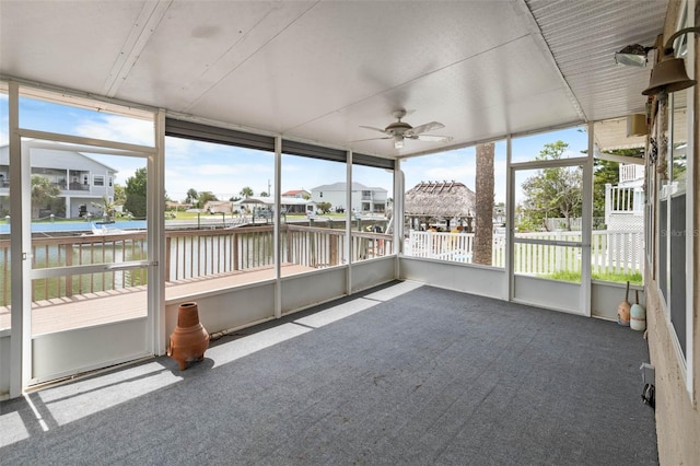 4299 Bellaire Dr, Hernando Beach, FL 34607 - unfurnished sunroom featuring a ceiling fan and a water view