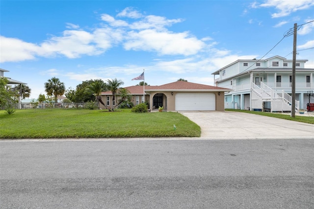 4299 Bellaire Dr, Hernando Beach, FL 34607 - view of front of home featuring an attached garage, driveway, a front lawn, and stucco siding