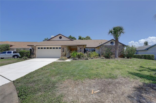 8521 Caitlin Ct, Hudson, FL 34667 - single story home with an attached garage, concrete driveway, and a front lawn