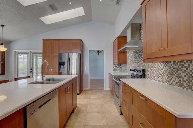 8521 Caitlin Ct, Hudson, FL 34667 - kitchen featuring appliances with stainless steel finishes, wall chimney range hood, a sink, a skylight, and decorative backsplash