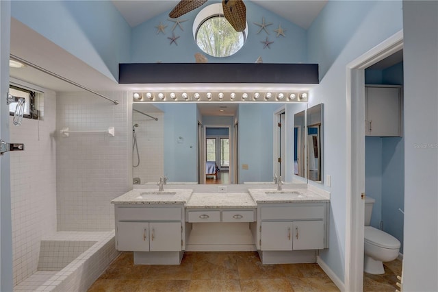 8521 Caitlin Ct, Hudson, FL 34667 - full bathroom with double vanity, tiled shower, toilet, and high vaulted ceiling