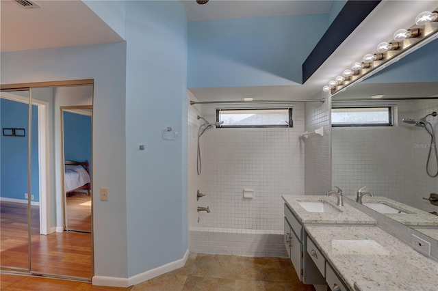 8521 Caitlin Ct, Hudson, FL 34667 - full bath with vanity, tub / shower combination, ensuite bath, and baseboards